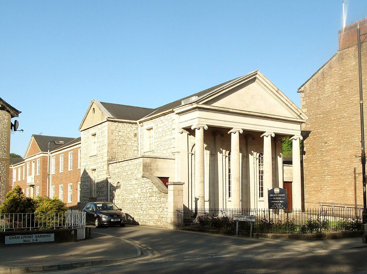 Classical columned front of Armagh County Museum on Mall East, with railings and a parked car