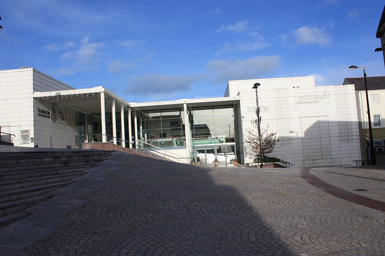 Paved square in Armagh's Market Place with the glass-fronted Market Place Theatre and Arts Centre and steps up to it