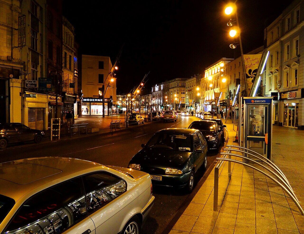 St Patrick Street, Cork, at night with parked cars under street lights
