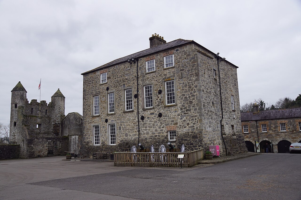 The turreted Watergate and the three-storey stone keep of Enniskillen Castle under a grey sky