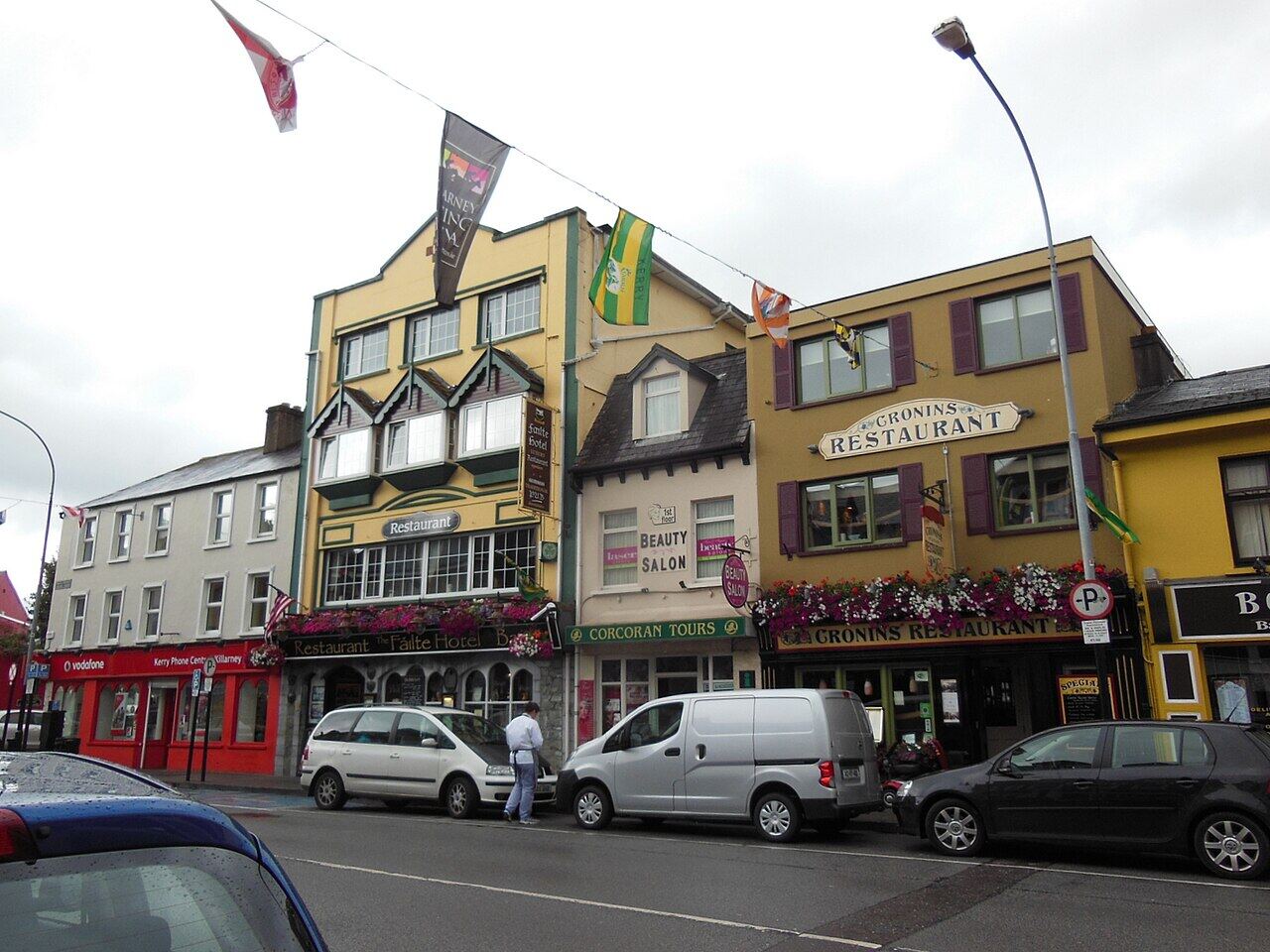 Shopfronts and parked vans on College Street, Killarney