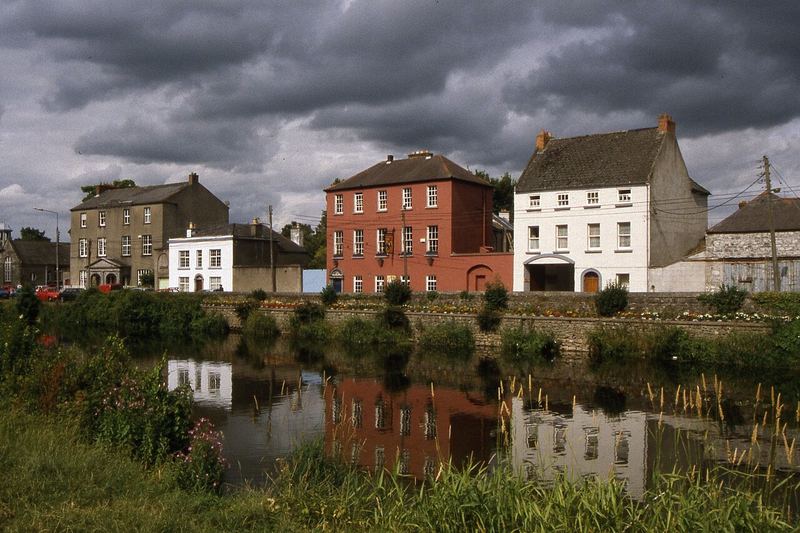 Houses on John's Quay reflected in the River Nore under heavy cloud