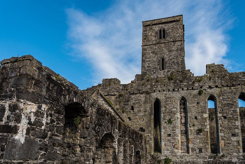 Stone tower and roofless walls of Sligo Abbey, the Dominican priory, under a blue sky