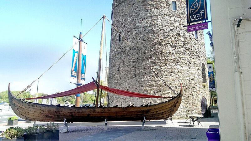 A replica Viking longship beside Reginald's Tower