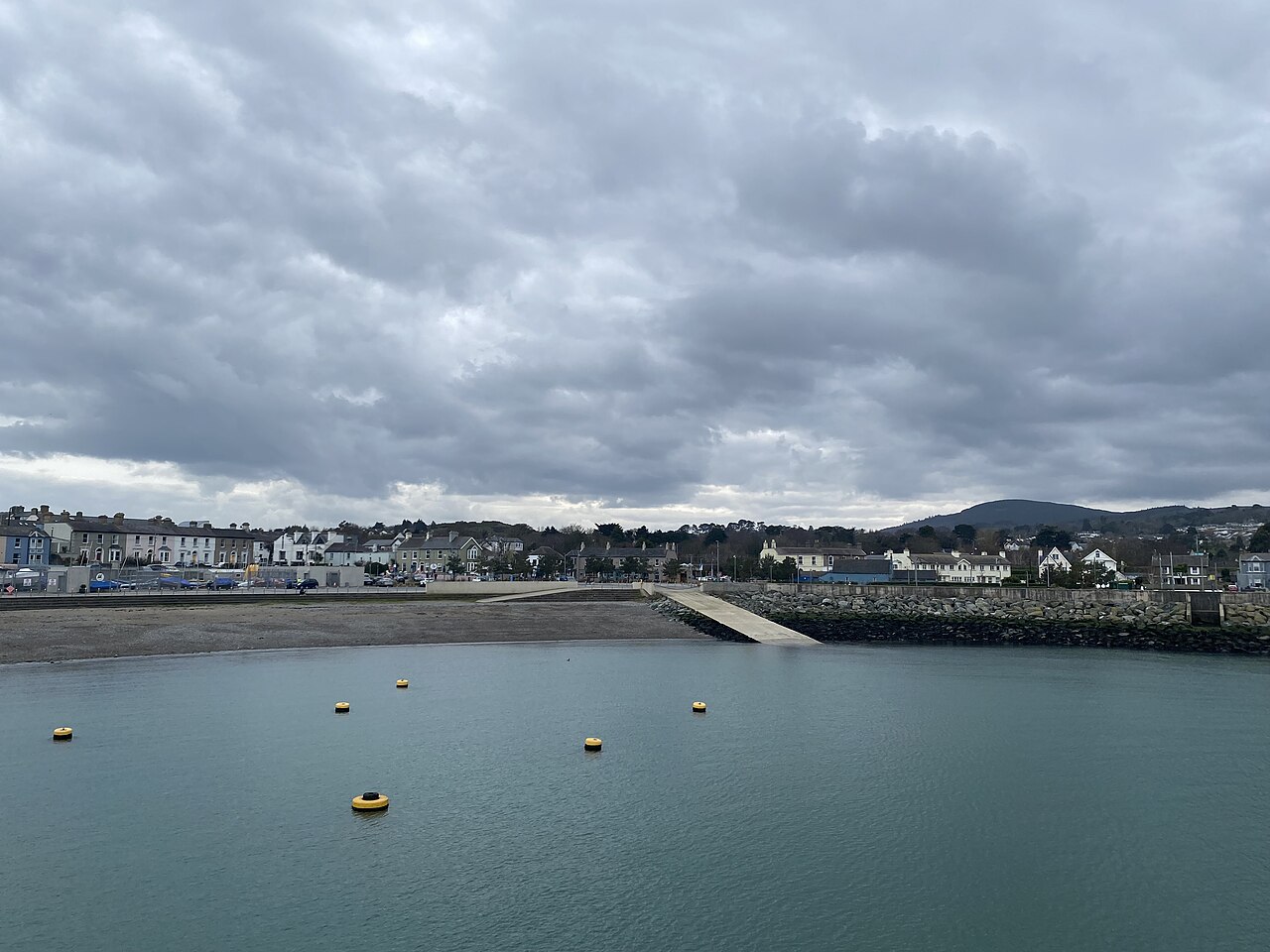 Greystones harbour water and moorings, with the seafront houses behind